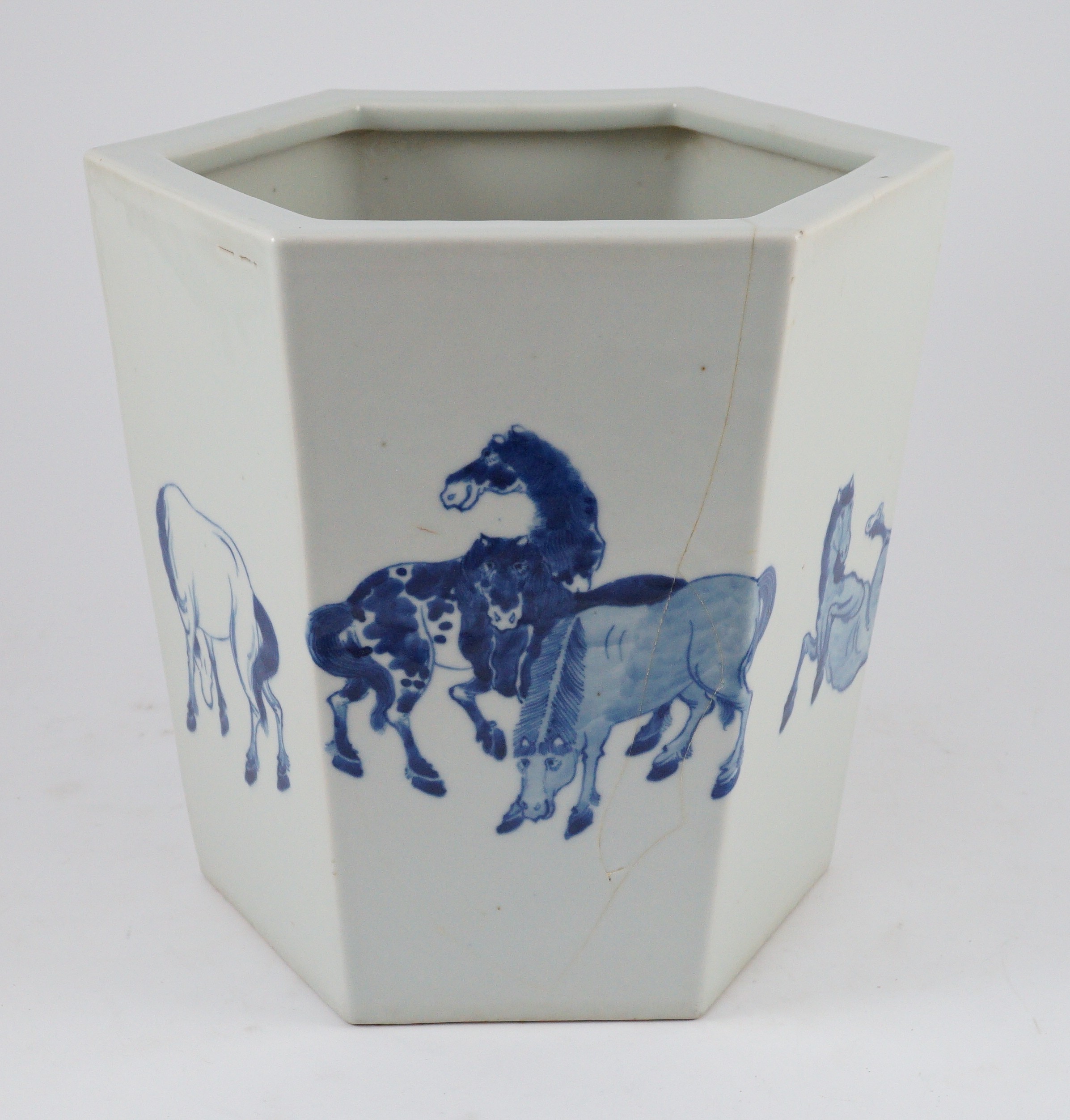 A Chinese blue and white hexagonal jardiniere, Kangxi mark but 19th/20th century, 26.5cm high, 28cm wide, cracked